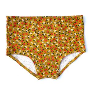 Braga alta dorada con flores de algodón orgánico